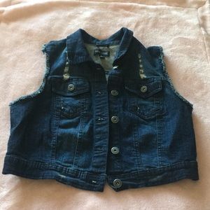 A dark blue jean vest
